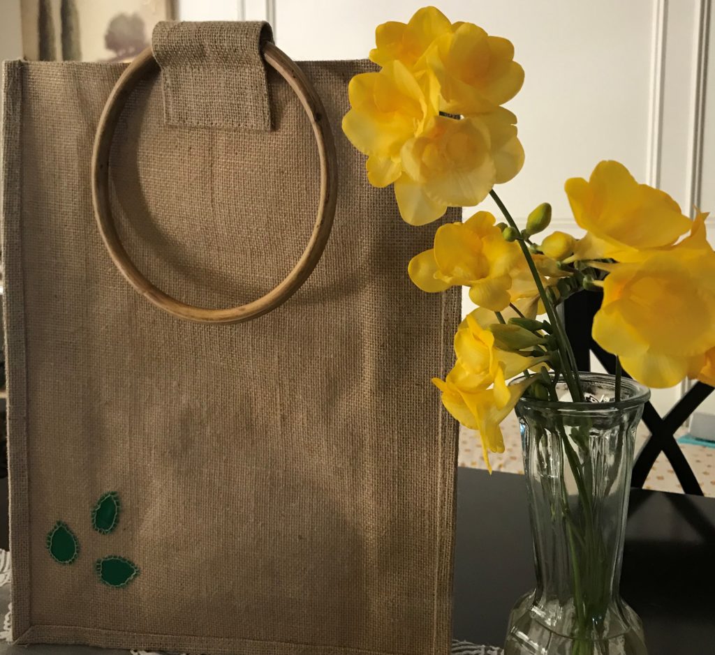 Jute bag beside a flower vase image