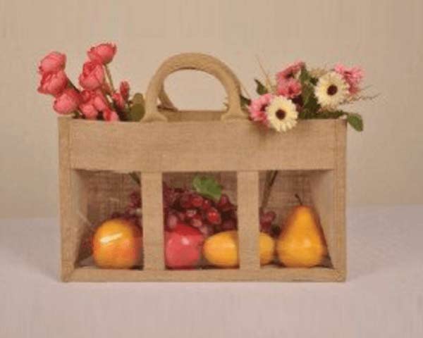 Jute bag holding fruits and flowers image